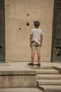 Boy staring at granite holes on the Human Rights Monument in Paris.
